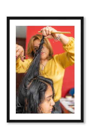 Hairdresser cutting hair of woman at home salon