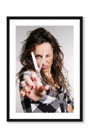 attractive hairdresser looking through scissors