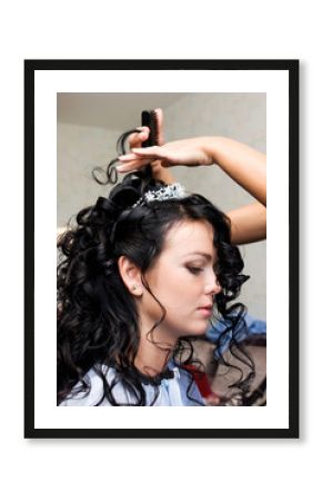 hairdresser preparing young bride for the wedding