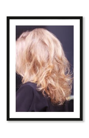 Female blond wavy hair. Back of woman head. Hairdressing salon.