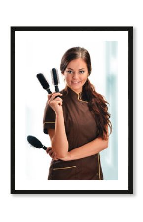 Professional hairdresser holding brushes