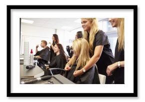 Teacher Helping Students Training To Become Hairdressers