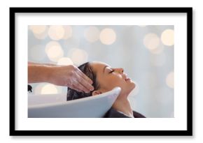 happy young woman having salon hair wash
