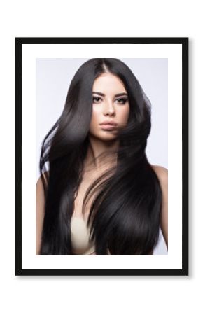 Beautiful brunette girl in move with a perfectly smooth hair, and classic make-up. Beauty face. 