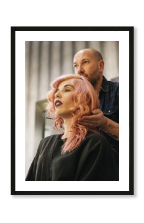 Beautiful woman getting haircut by hairdresser.