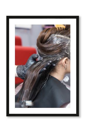 A brunette girl having her hair coloring