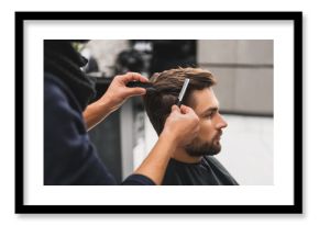 Male client getting haircut by hairdresser