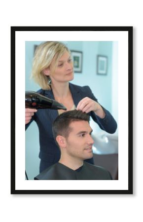 hairdresser drying hair of a man
