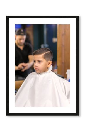 the boy is cut in hairdressing salon