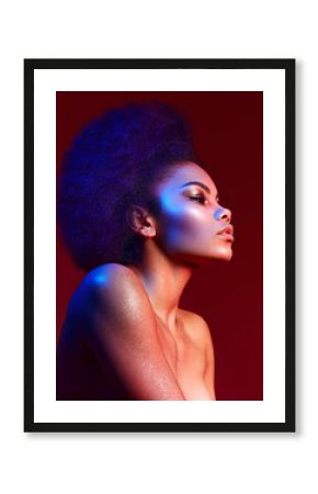 Beautiful dark-haired girl in profile on a claret background. Bright makeup and curvy hair in the style of "Afro". Color filters.