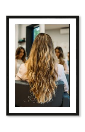 Woman with long hair sitting in a hairdresser