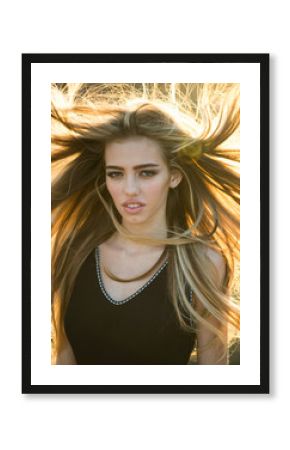 Blonde woman with curly beautiful hair. Beauty hair Salon. Fashion haircut. Beauty girl with long and shiny wavy hair. Trendy haircuts. Long healthy hair