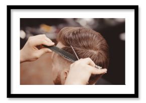 Close-up, master hairdresser does hairstyle with scissors comb. Concept Barbershop
