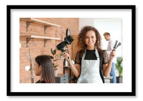 Young African-American hairdresser in beauty salon
