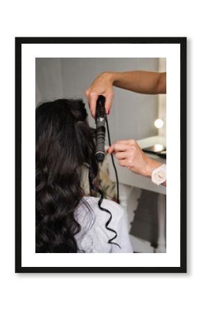 Hairdresser makes hairstyle to client. Hairdressing services. Creating hairstyle. Hair styling process. Beauty service concept