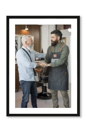 Client and barber greeting each other at barbershop