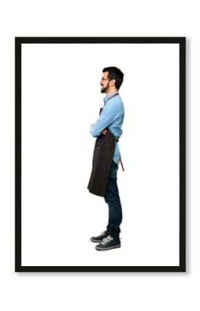 Full-length shot of Man with apron in lateral position over isolated white background