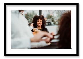 Beautiful latin woman with short curly brown hair getting a treat at the hairdresser. Latin hairdresser working her afro hair. Lifestyle