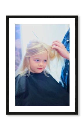 Cute little girl in hairdressing salon. Selective focus