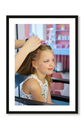 Hairdressing services. Reating hairstyle. Hair styling process. Children hairdressing salon