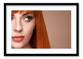 Beautiful young woman with a bright makeup and a smooth long hair holds metal scissors. Model with red hair. Hair salon, haircut. Care and beauty hair products. Perfect make-up