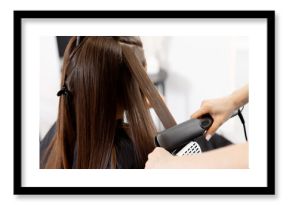 Professional hair straightening at salon for young caucasian woman