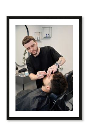 Barber carefully applies wax to remove hair from nose