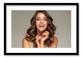 Beautiful white-toothed smiling woman   with long  and   shiny wavy  hair .  Beauty happy model girl with curly hairstyle . Gorgeous white teeth in a smile