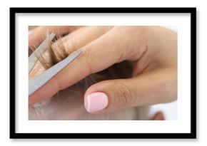 Hand of master hairdresser holds scissors and blond hair baby. Trendy kids haircut concept