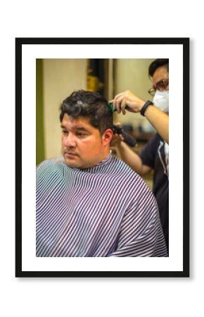 Man visiting hairstylist in barbershop. 