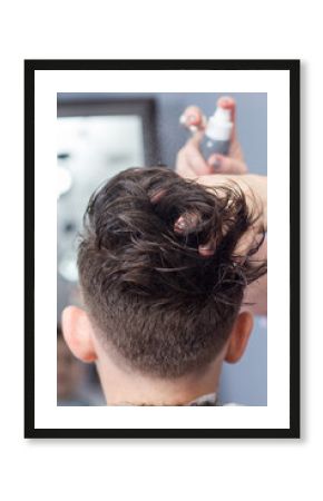 Professional hairdresser makes hairstyle for a boy, vertical