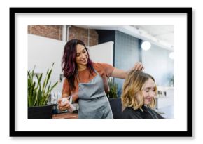 Hairstylist spraying a mouse on her customer& 39 s hair