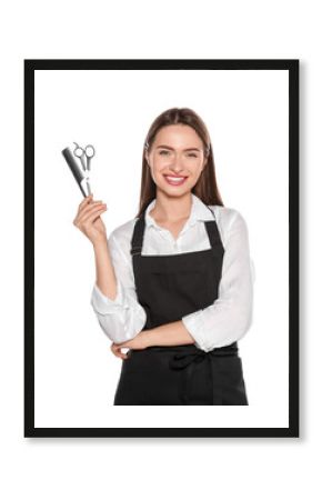 Portrait of happy hairdresser with scissors and comb on white background