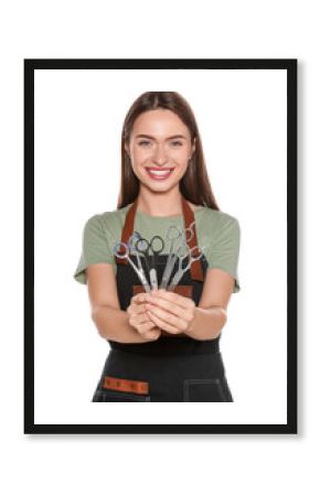 Portrait of happy hairdresser with professional scissors on white background