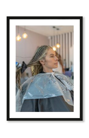 model in the beauty salon, beautiful woman painting her hair in the hairdresser or beauty salon and making up pretty for a party or a wedding