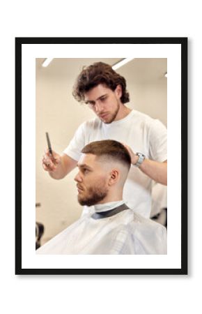 hairdresser does haircut for caucasian bearded man