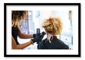 Professional stylist working on a client's curly hair