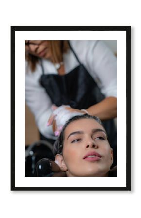 Professional hairdresser provides expert shampooing service in salon, ensuring optimal hair cleanliness and health