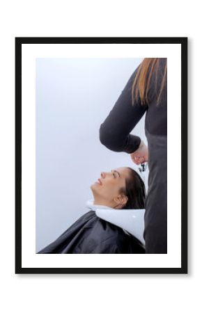 Woman professional hairdresser washing hair in a beauty salon, doing hair styling to client in beauty salon, stylist doing hair care procedures
