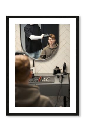 Photo of handsome boy in contemporary hairdressing salon