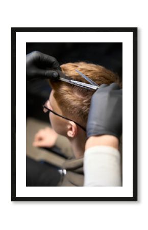 Cropped view of Caucasian hairstylist serving visitor in hairdressing salon