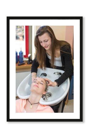 hairstylist washing customers hair