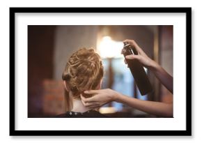 Female hairdresser styling customers hair