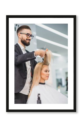 Smiling male stylist is serving a woman