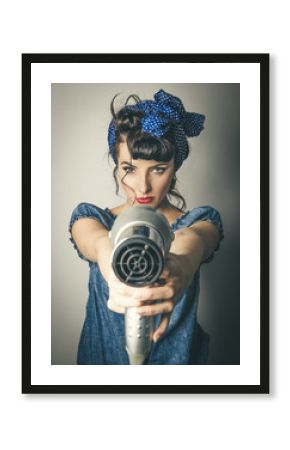 Woman in vintage clothes pointing hairdryer