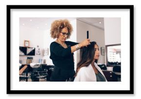 Woman hairdresser at work in salon