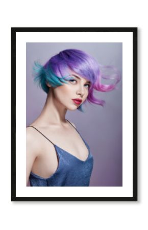 Portrait of a woman with bright colored flying hair, all shades of purple. Hair coloring, beautiful lips and makeup. Hair fluttering in the wind. Sexy girl with short hair