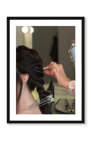 Hairdressing services. Process of creating hairdo. Hairdresser makes hairstyle to client. Party image. Beauty industry