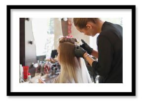 A hairdresser is installing the upgrade of hair extension.