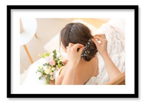 Professional hairdresser working with young bride at home